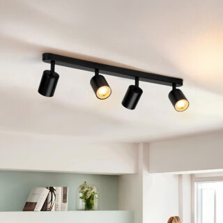 plafonnier spot minimaliste noir contenant 4 spot illuminant de part et d'autre sur un plafond blanc